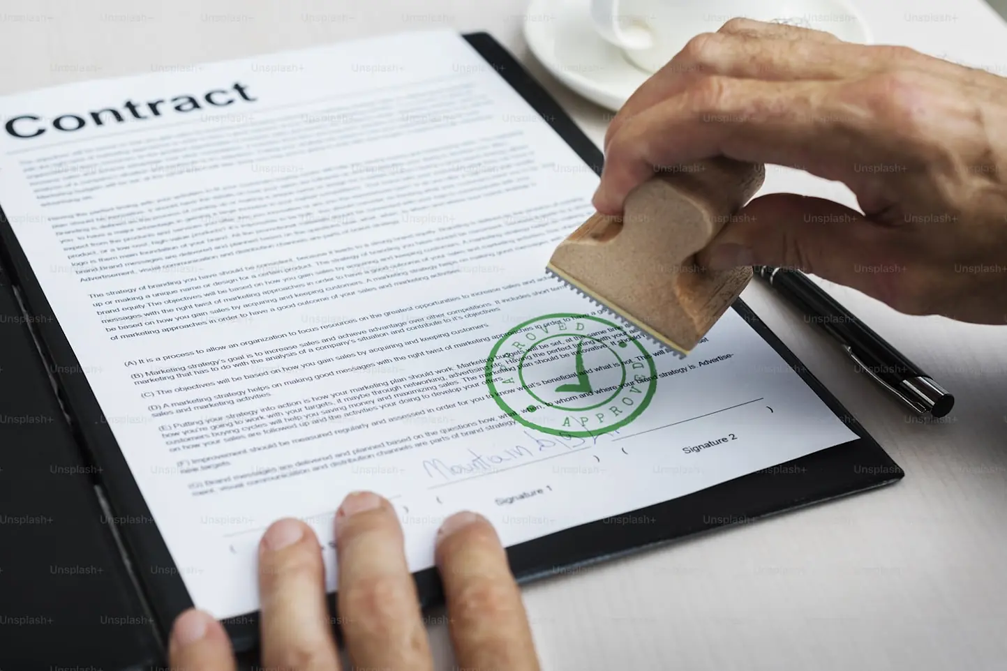 A contract being stamped and signed